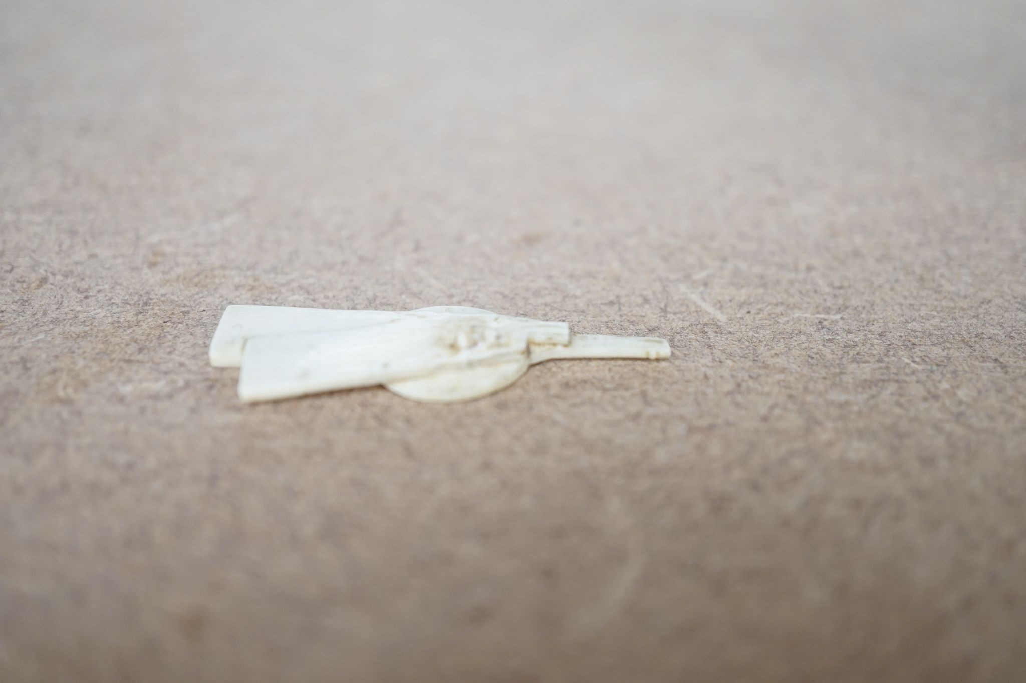 A Japanese ivory okimono of a street vendor, early 20th century 12cm